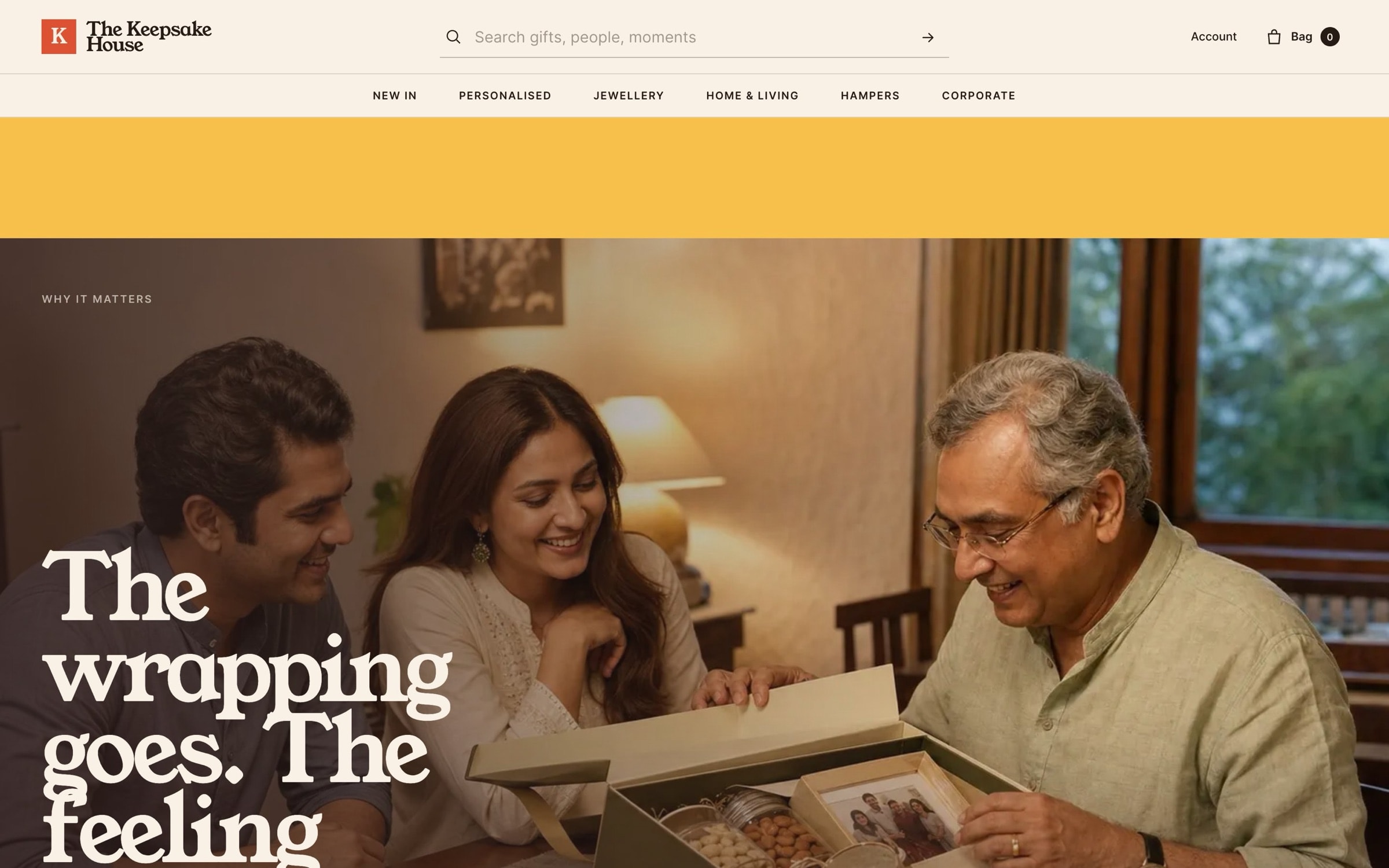 ‘The wrapping goes. The feeling stays.’ over a family looking through a photo album.